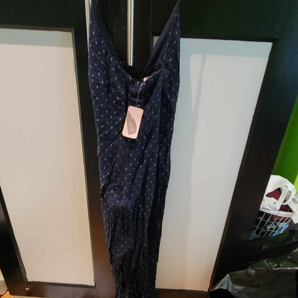navy blue jump suit with floral detail at ankles
